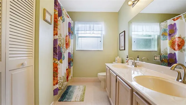 a bedroom with a bed and a mirror on the dresser