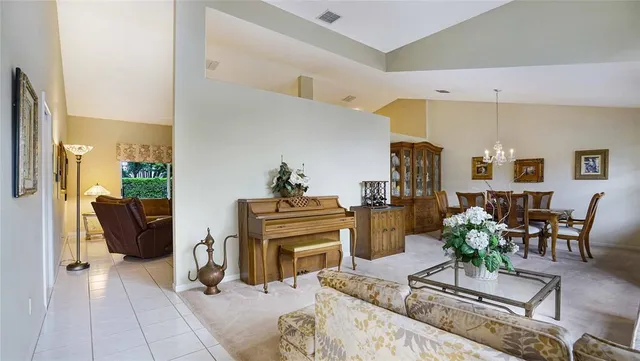 a living room with furniture potted plant and a table