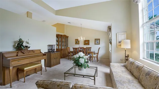 a living room with furniture and a chandelier