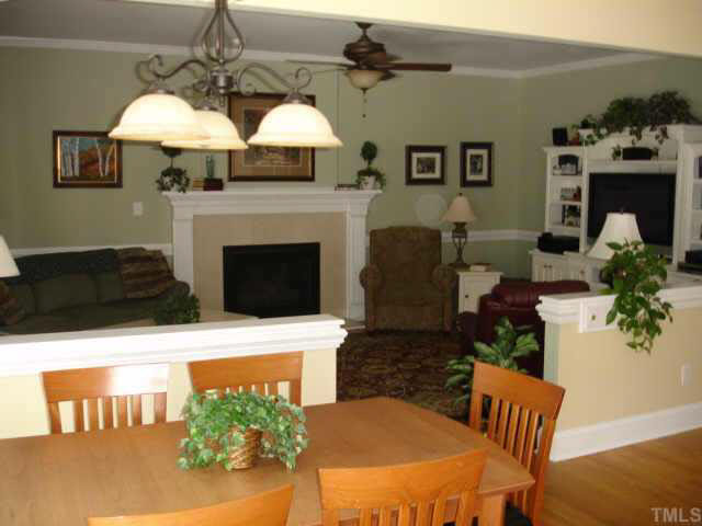 2708 Amstel Way Raleigh, NC 27613 - Photo 4 of 10 a living room with furniture a fireplace and a chandelier