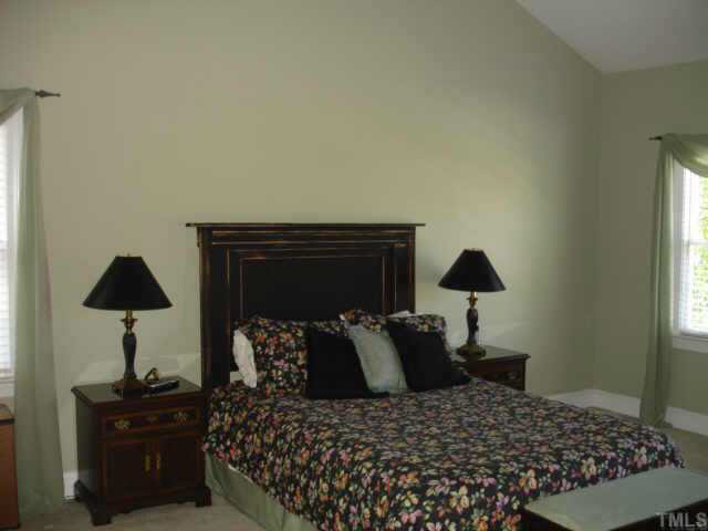 2708 Amstel Way Raleigh, NC 27613 - Photo 8 of 10 a bedroom with a bed and a lamp