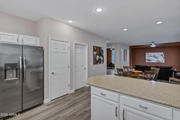 a view of a living room kitchen and entryway