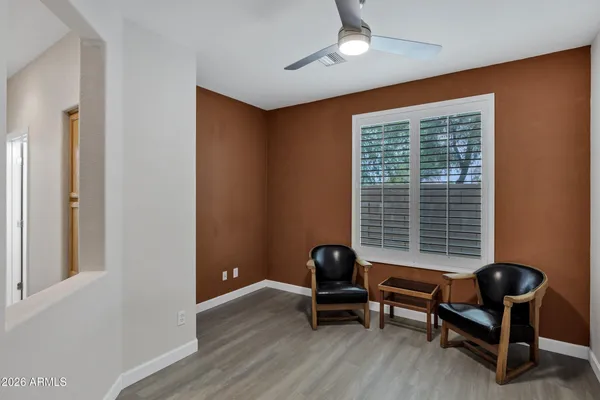 a view of a livingroom with lounge chair and a window