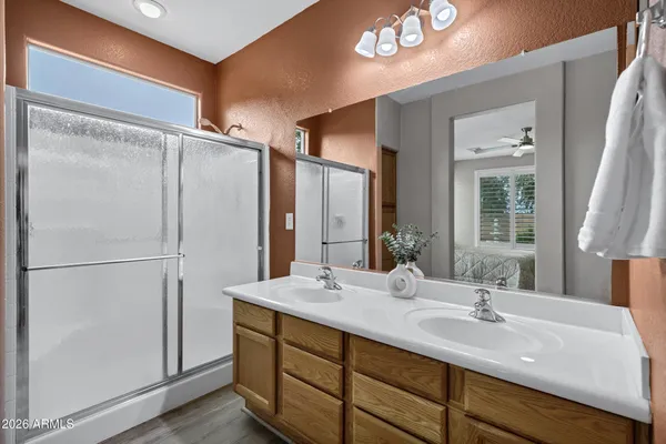 a bathroom with a double vanity sink and mirror