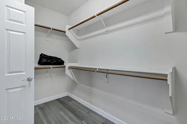 a view of walk in closet with empty racks