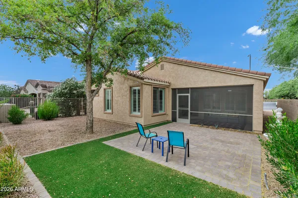 a house view with a sitting space and garden
