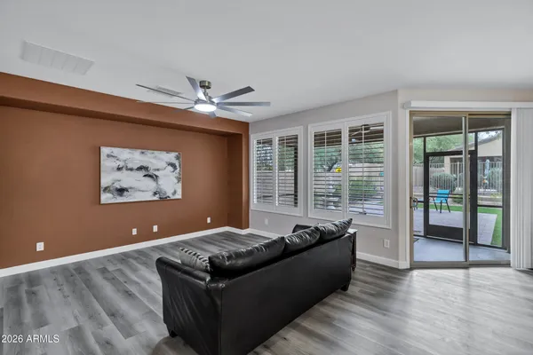 a living room with furniture ceiling fan and a window