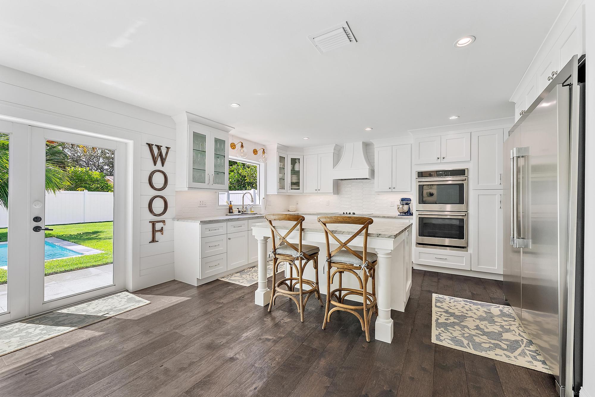 8 Windsor Road West Jupiter, FL 33469 - Photo 13 of 32 a kitchen with stainless steel appliances granite countertop a refrigerator and microwave