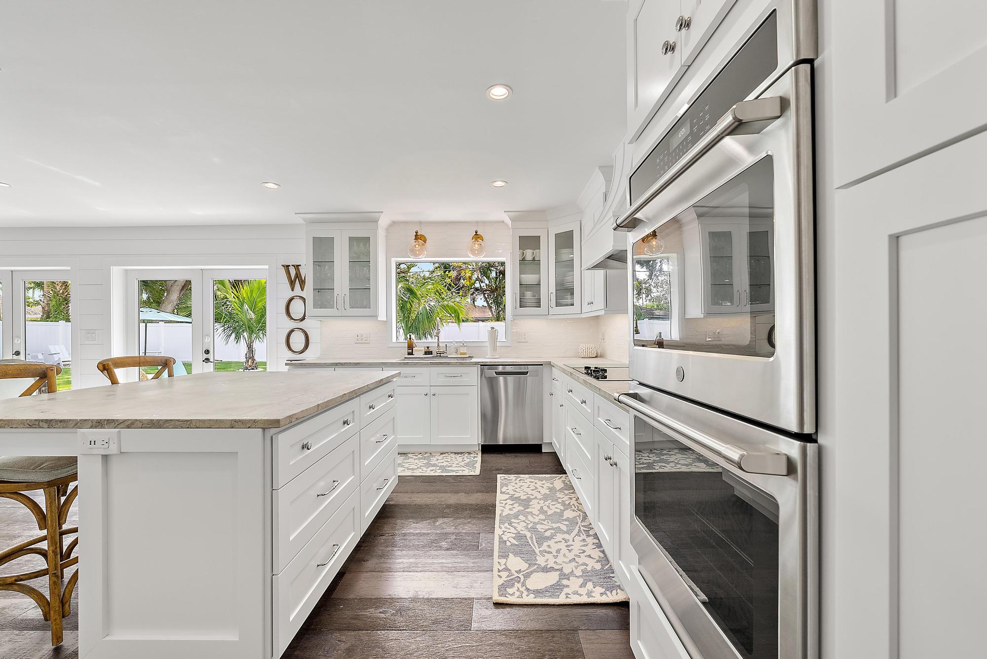8 Windsor Road West Jupiter, FL 33469 - Photo 15 of 32 a kitchen with granite countertop a sink stainless steel appliances and cabinets