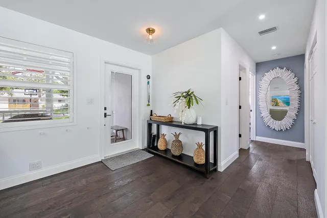 a view of an empty room and wooden floor