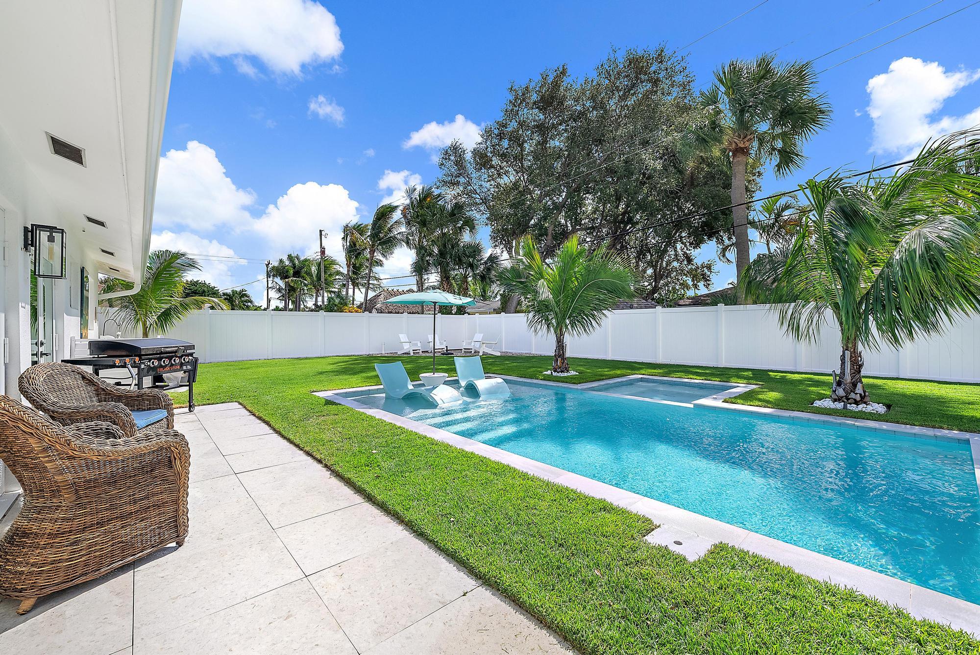 8 Windsor Road West Jupiter, FL 33469 - Photo 2 of 32 a view of backyard with swimming pool and outdoor seating