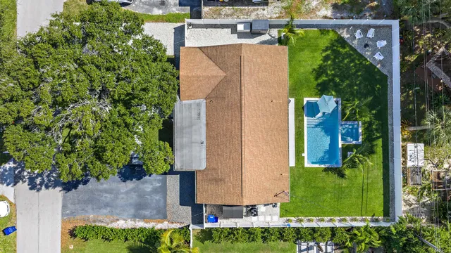 an aerial view of a house with a yard basket ball court and outdoor seating