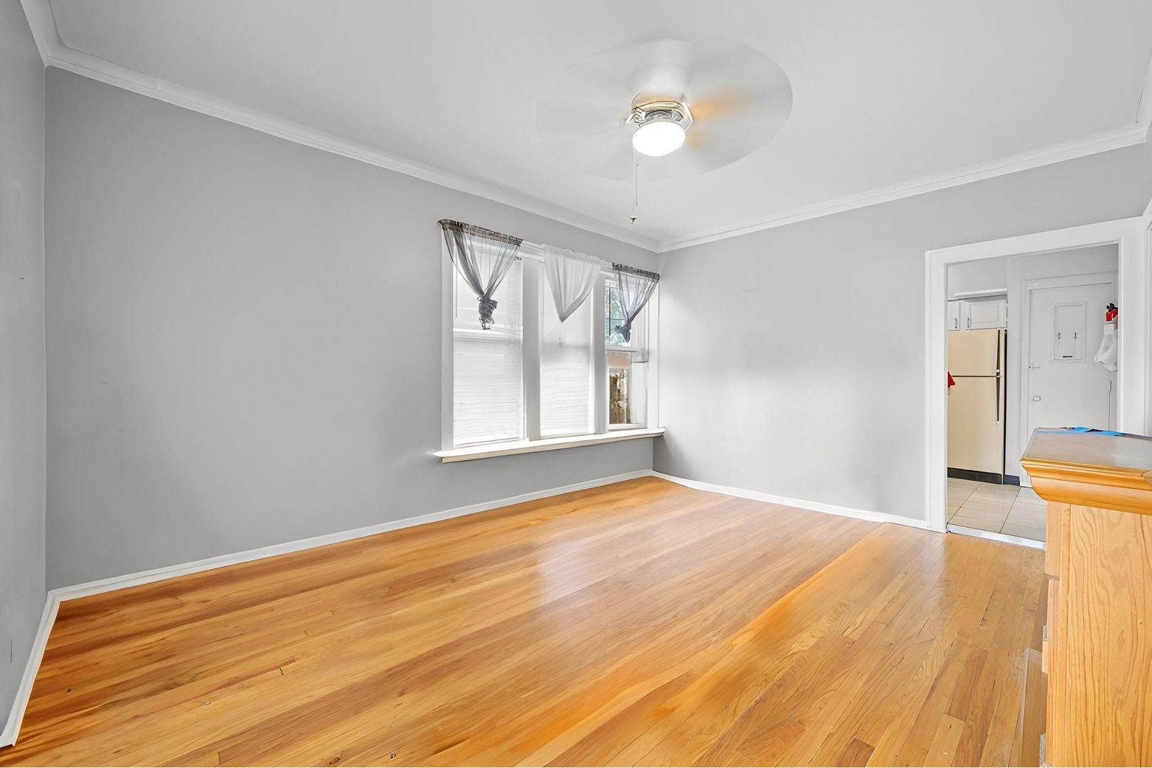 6058 South Massasoit Avenue Chicago, IL 60638 - Photo 13 of 45 a view of empty room with wooden floor and fan