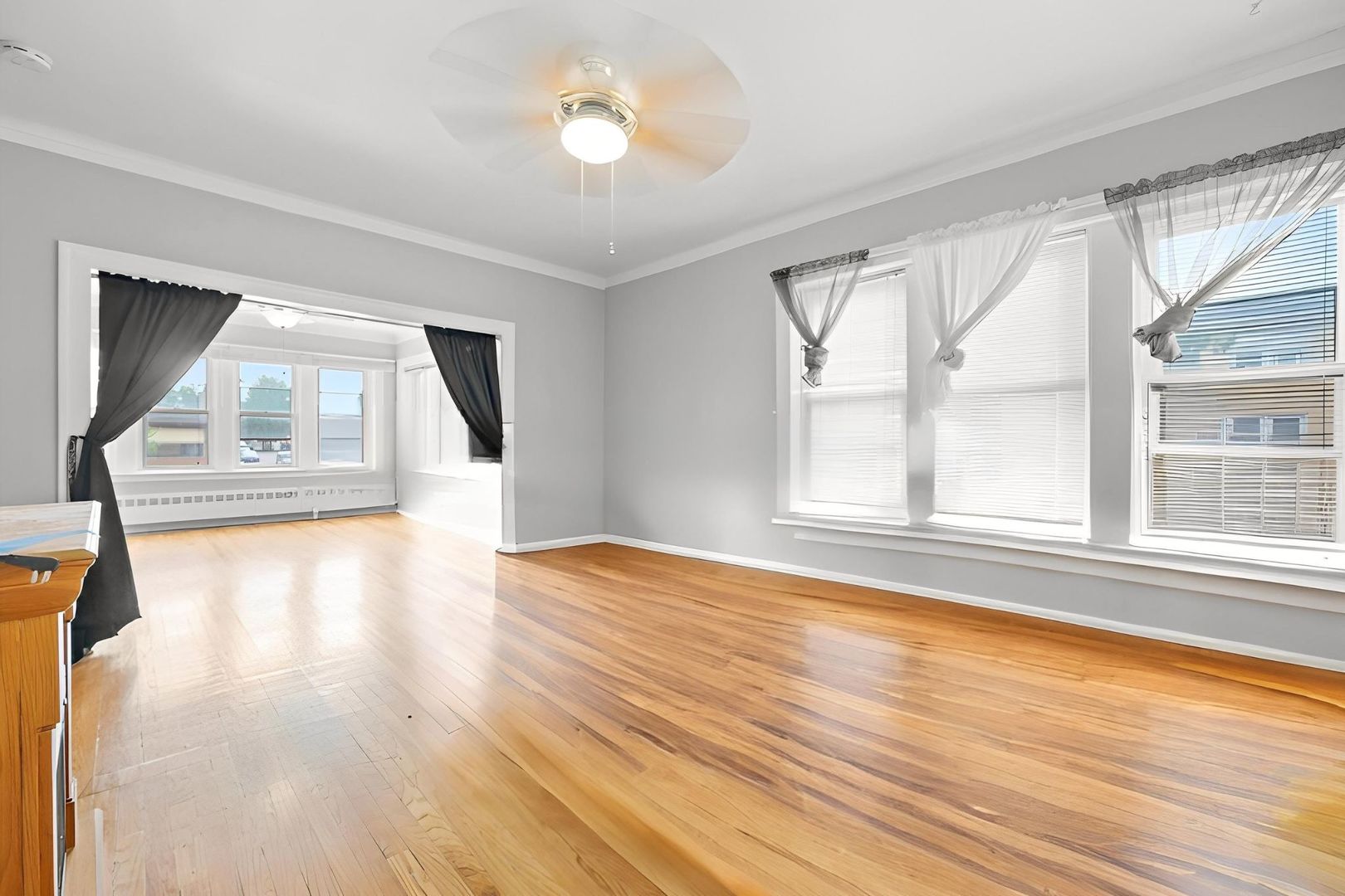 6058 South Massasoit Avenue Chicago, IL 60638 - Photo 14 of 45 a view of empty room with wooden floor and fan