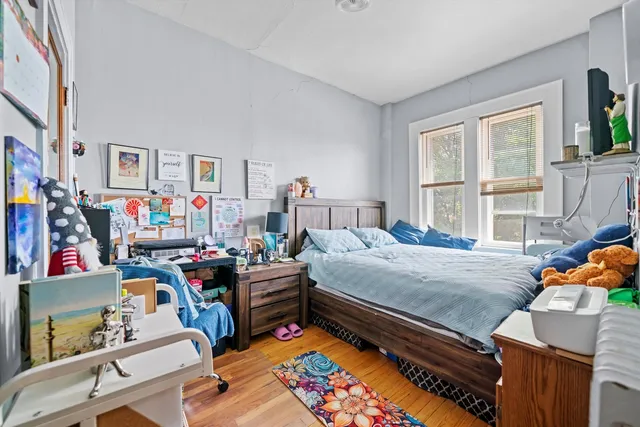a bedroom with furniture and a wooden floor