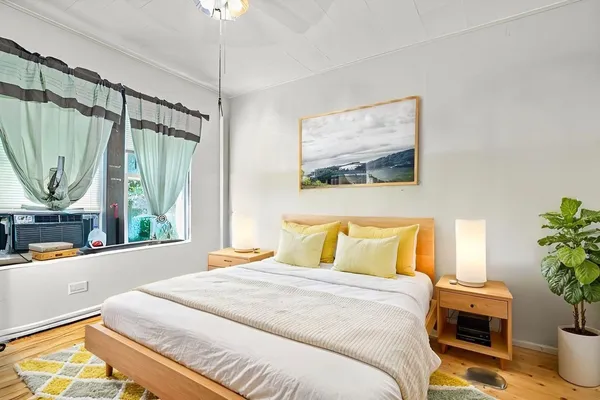 a bedroom with a bed and a chandelier