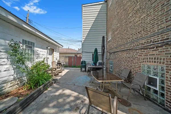 a view of a patio with table and chairs and potted plants
