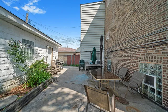 a view of a patio with table and chairs and potted plants
