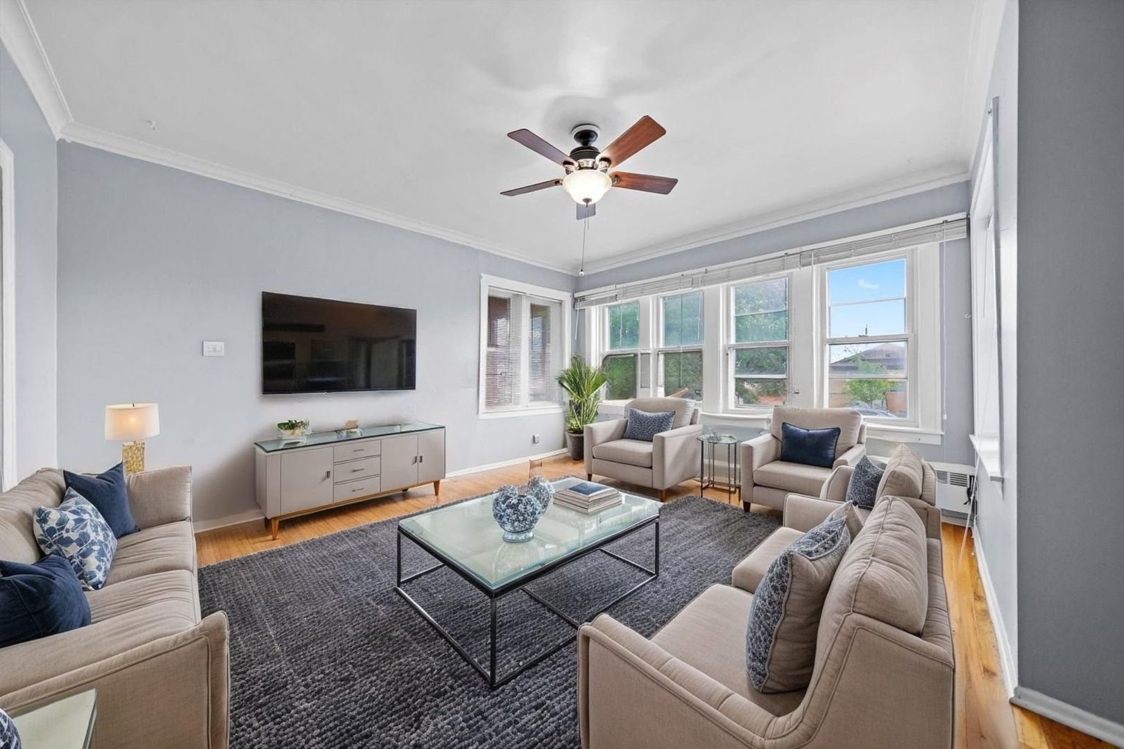 6058 South Massasoit Avenue Chicago, IL 60638 - Photo 5 of 45 a living room with furniture a flat screen tv and a large window