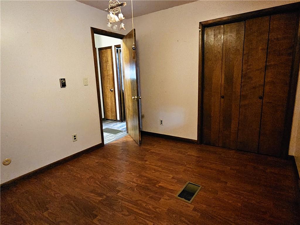 615 Fallen Timbers Road Point Marion, PA 15474 - Photo 28 of 44 an empty room with wooden floor and mirror