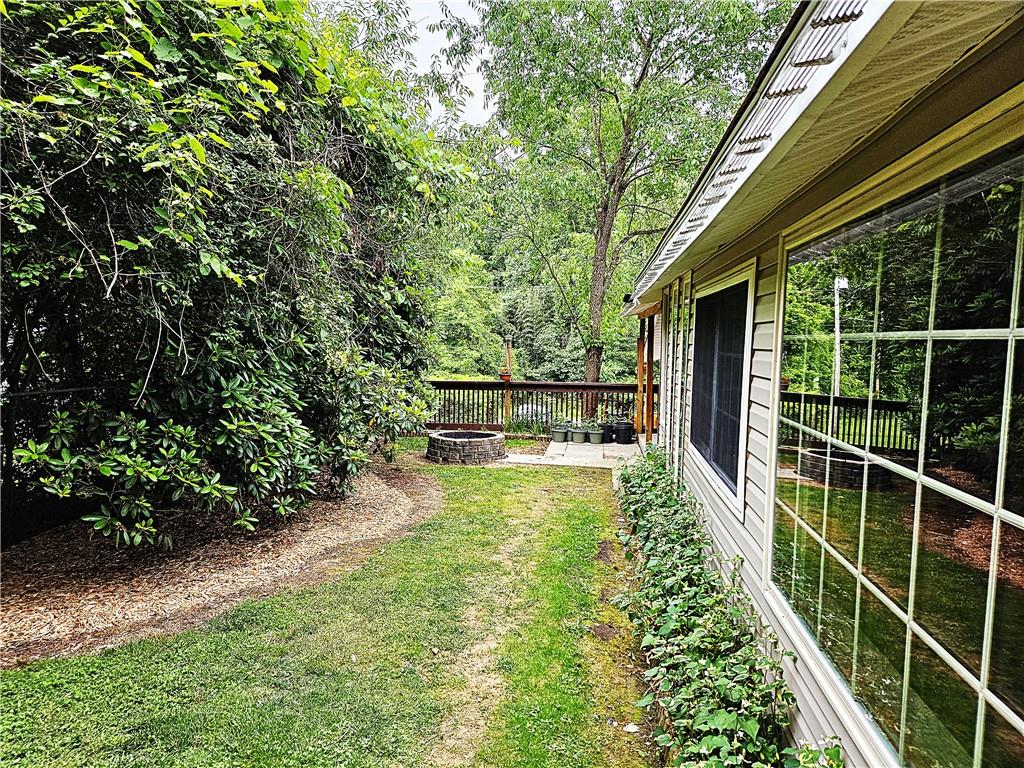 615 Fallen Timbers Road Point Marion, PA 15474 - Photo 3 of 44 a view of a backyard with table and chairs and potted plants