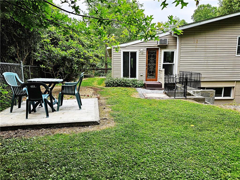 615 Fallen Timbers Road Point Marion, PA 15474 - Photo 39 of 44 a view of a patio with table and chairs and potted plants with wooden floor