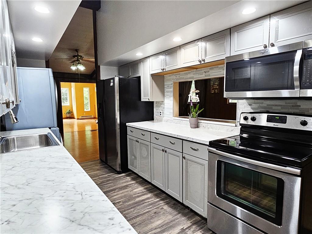 615 Fallen Timbers Road Point Marion, PA 15474 - Photo 5 of 44 a kitchen with stainless steel appliances wooden cabinets sink and microwave