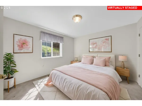 a bedroom with a bed and a potted plant