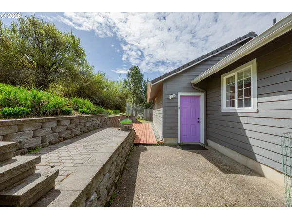 a view of house with a yard and sitting area