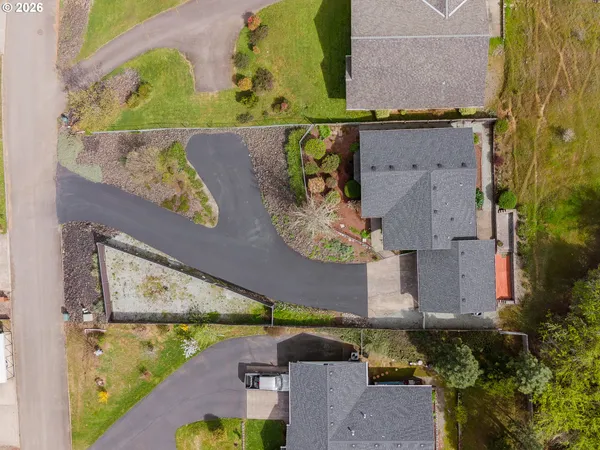 an aerial view of a house with a swimming pool