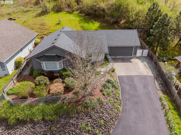 an aerial view of a house with a yard and lake view