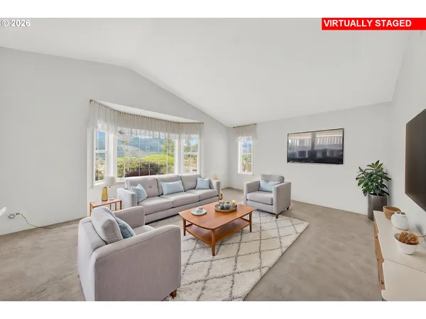 a living room with furniture and a large window