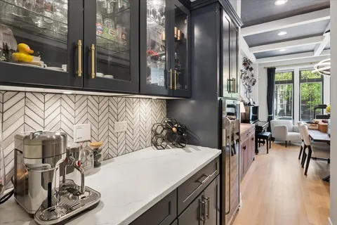 a kitchen with stainless steel appliances kitchen island granite countertop a sink and a stove