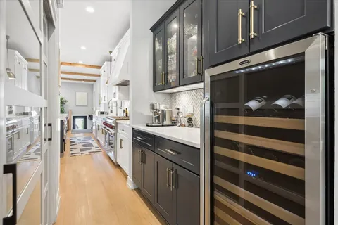 a kitchen with stainless steel appliances granite countertop a sink a stove a refrigerator and a refrigerator