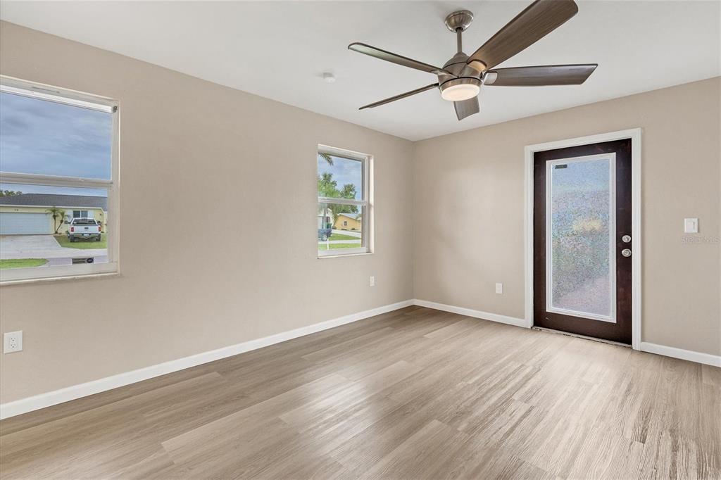 76 Caddy Road Rotonda West, FL 33947 - Photo 11 of 62 a view of an empty room with window and wooden floor