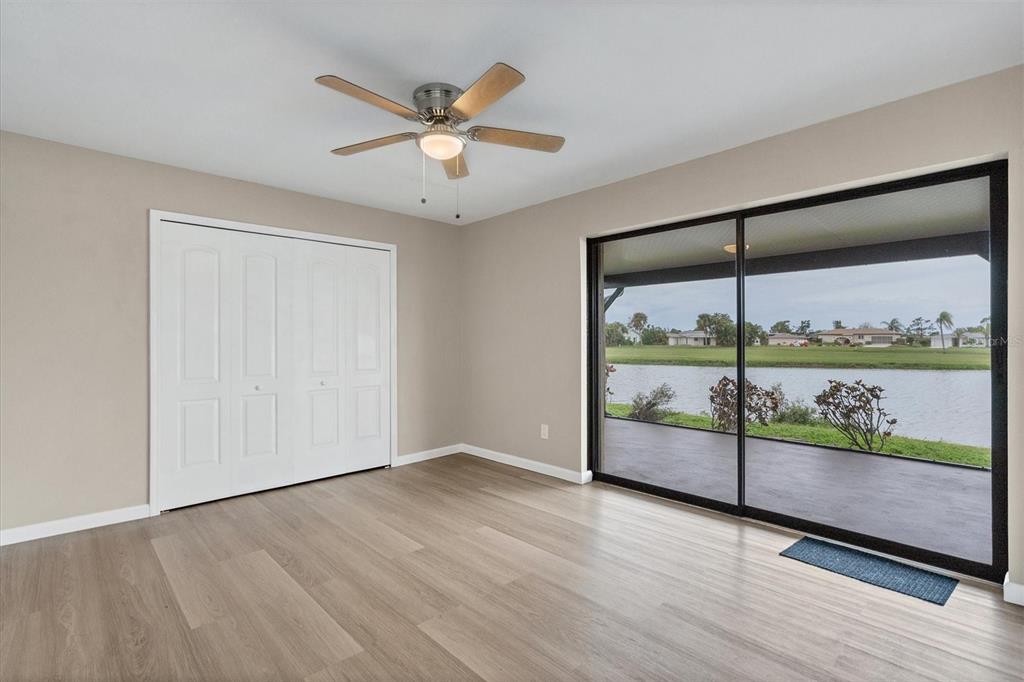76 Caddy Road Rotonda West, FL 33947 - Photo 20 of 62 an empty room with wooden floor and windows