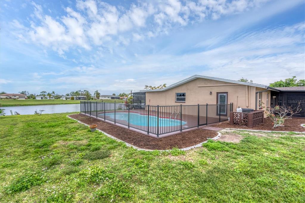 76 Caddy Road Rotonda West, FL 33947 - Photo 40 of 62 a view of a house with a yard and sitting area