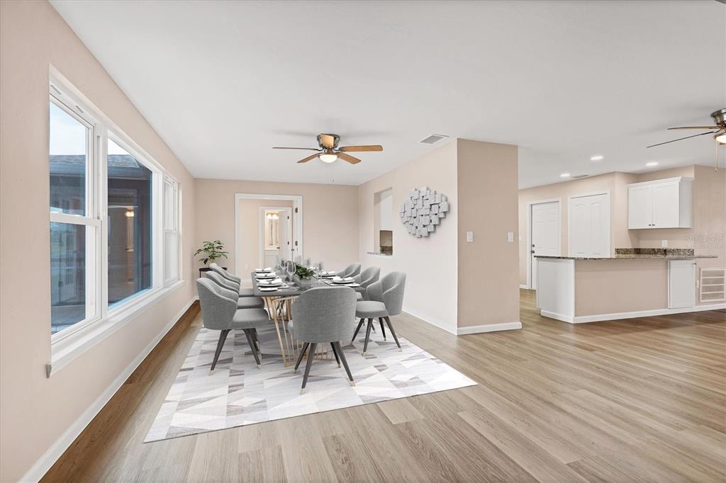 76 Caddy Road Rotonda West, FL 33947 - Photo 4 of 62 a view of a dining room with furniture and wooden floor