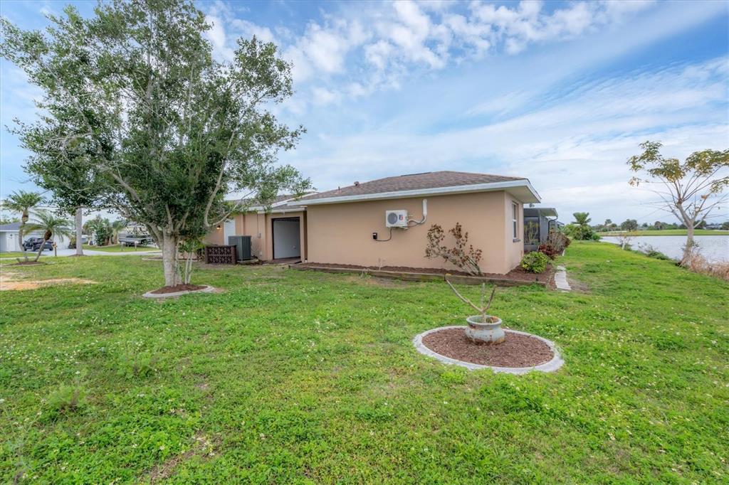 76 Caddy Road Rotonda West, FL 33947 - Photo 45 of 62 a view of a backyard with a garden and entertaining space