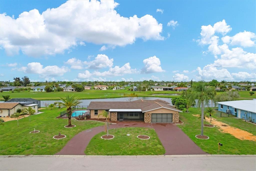 76 Caddy Road Rotonda West, FL 33947 - Photo 46 of 62 a view of an outdoor space yard patio and lake view