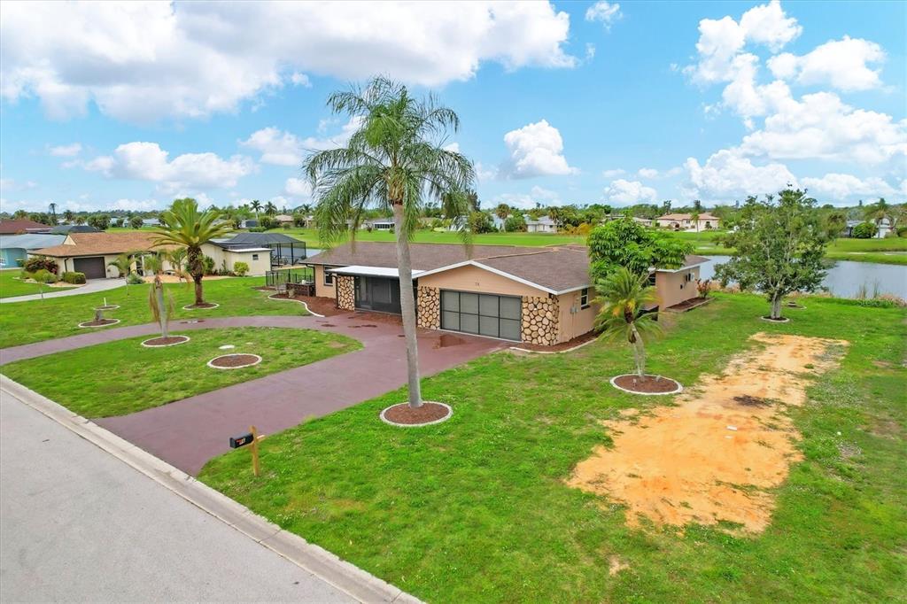 76 Caddy Road Rotonda West, FL 33947 - Photo 47 of 62 a view of a house with a big yard