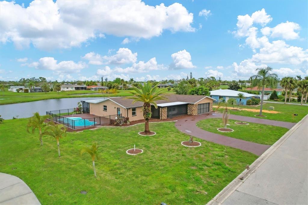 76 Caddy Road Rotonda West, FL 33947 - Photo 57 of 62 a view of a lake with a garden