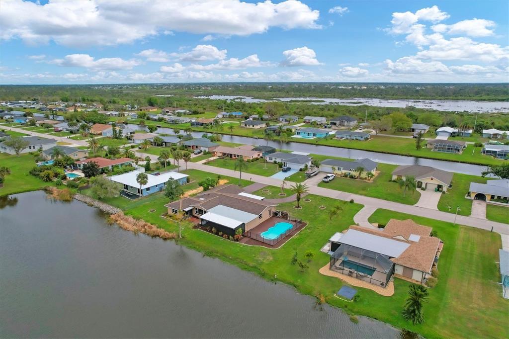 76 Caddy Road Rotonda West, FL 33947 - Photo 60 of 62 an aerial view of a house with a garden
