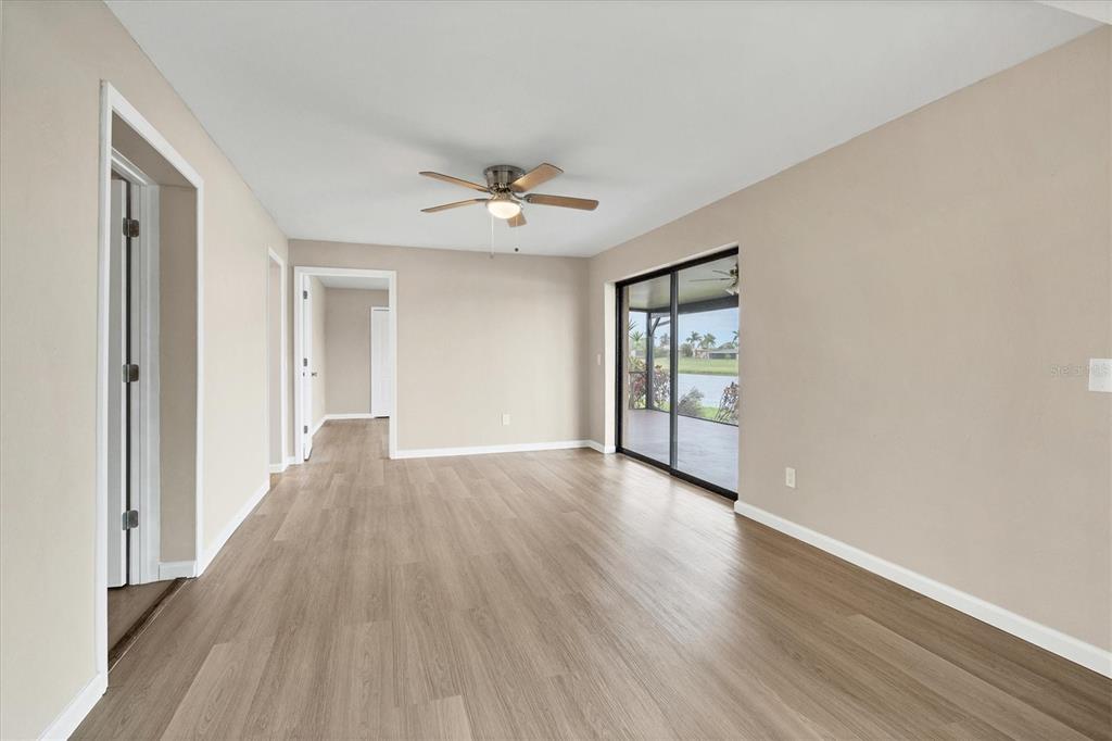 76 Caddy Road Rotonda West, FL 33947 - Photo 7 of 62 a view of an empty room with a window and wooden floor