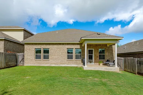 a view of a house with a backyard