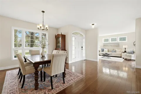 a view of a dining room with furniture wooden floor and chandelier