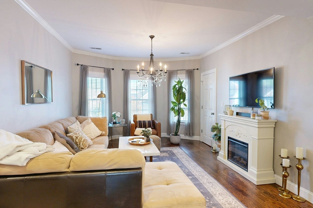 a living room with furniture fireplace and window