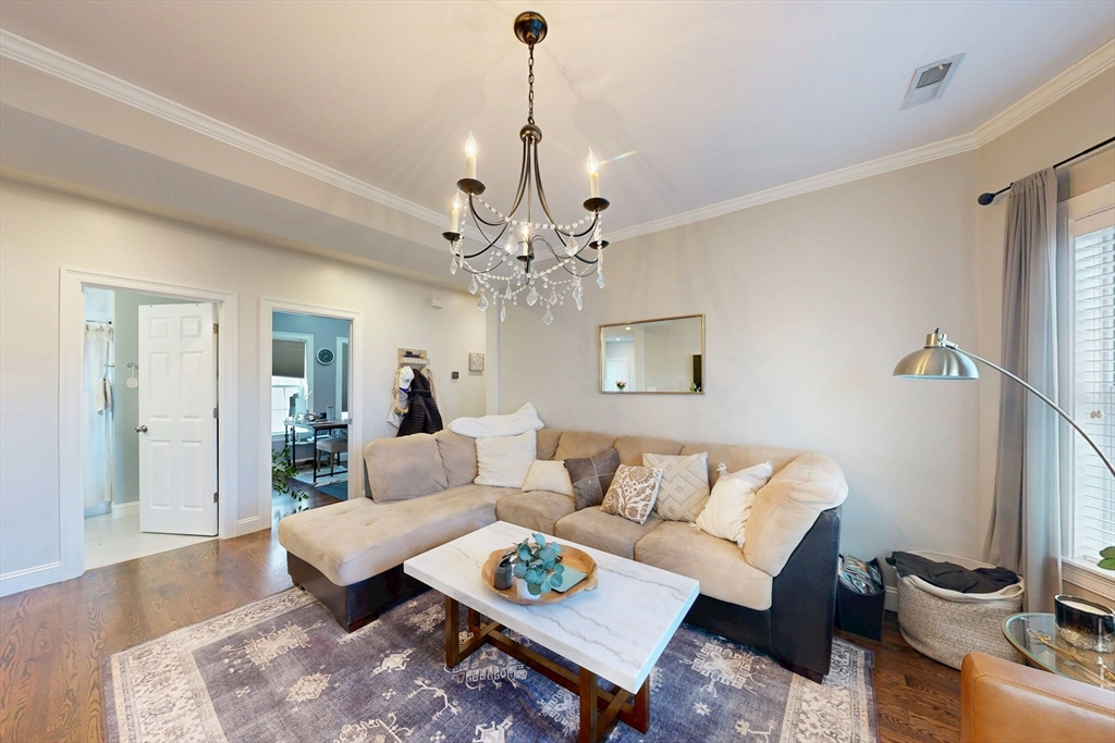 38 Pearl Street, Unit 3 Everett, MA 02149 - Photo 3 of 14 a living room with furniture a table and decor