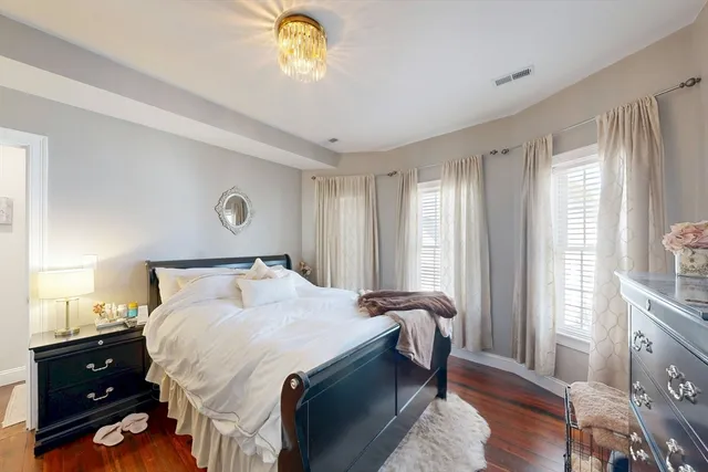 a bedroom with a bed and a chandelier