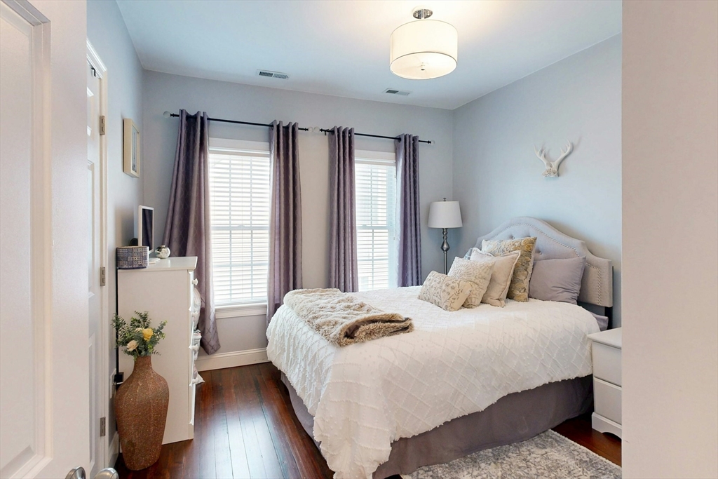 38 Pearl Street, Unit 3 Everett, MA 02149 - Photo 10 of 14 a bedroom with a bed and wooden floor